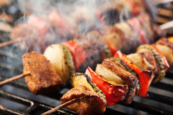 Grilling shashlik on barbecue grill. Selective focus